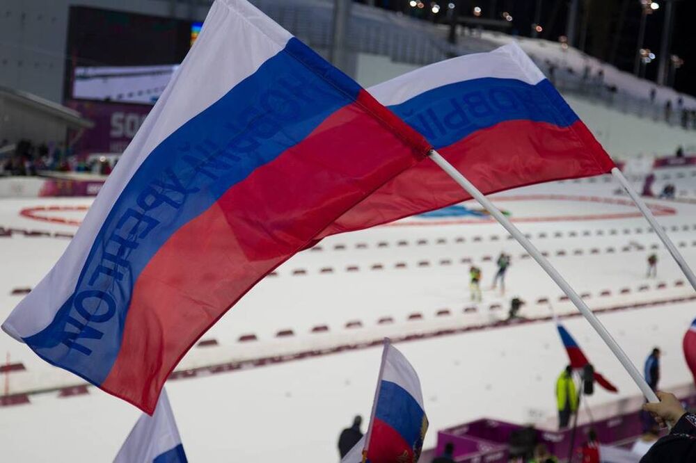 22.02.2014, Sochi, Russia (RUS): Event Feature: Russian flags with Athletes competing on the track- XXII. Olympic Winter Games Sochi 2014, biathlon, relay men, Sochi (RUS). www.nordicfocus.com. © NordicFocus. Every downloaded picture is fee-liable.