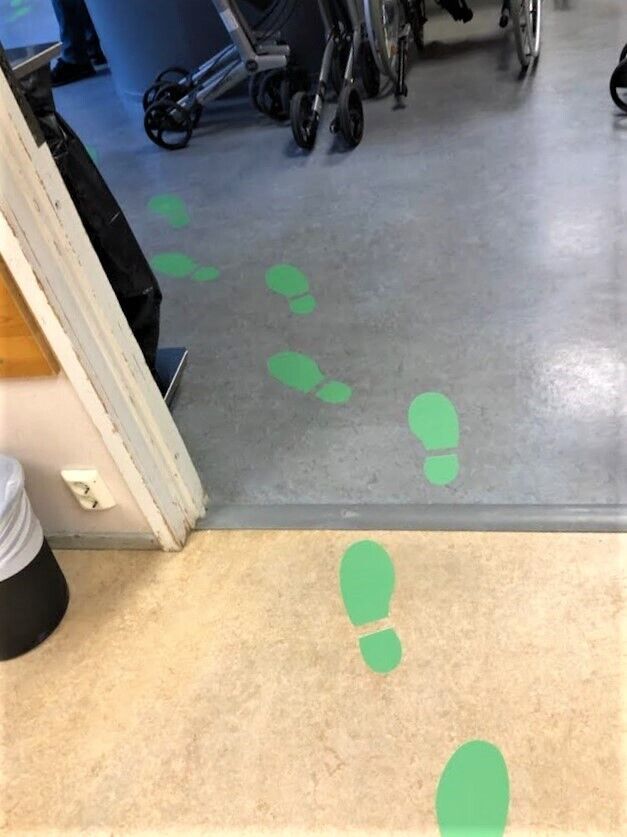 På gulvet er det merket med grønne spor der hvor det er lov å gå
