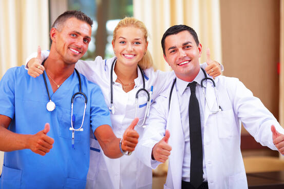 Happy group of doctors showing thumbs up