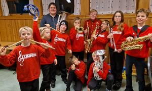 Glade skolekorpsmusikere i Lunner med røde korpsgensere og