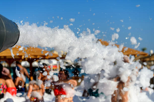 Fun foam party on the beach. Close texture foam on a blue sky background