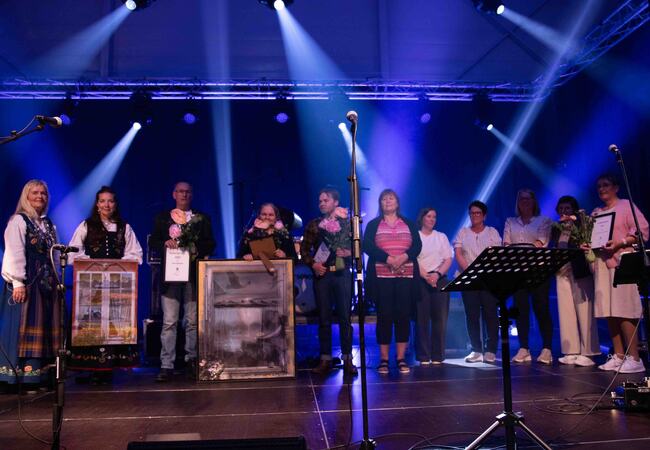Fjorårets prisvinnere samlet på scenen i Herøyhallen under kulturkvelden. (Foto: Pål Nikolaisen) Fjorårets prisvinnerne samlet til hyllest fra publikum. (Foto: Pål Nikolaisen)
