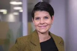 - Ordbøkene skal ikkje berre samle ord, men hjelpe til med å forvalte norsk språk på ein måte som er presis, oppdatert og berekraftig, sa Margunn Rauset. Foto: Frode Ims / UiB Kvinne med mørkt ganske kort hår og brune øyne. Brun jakke.